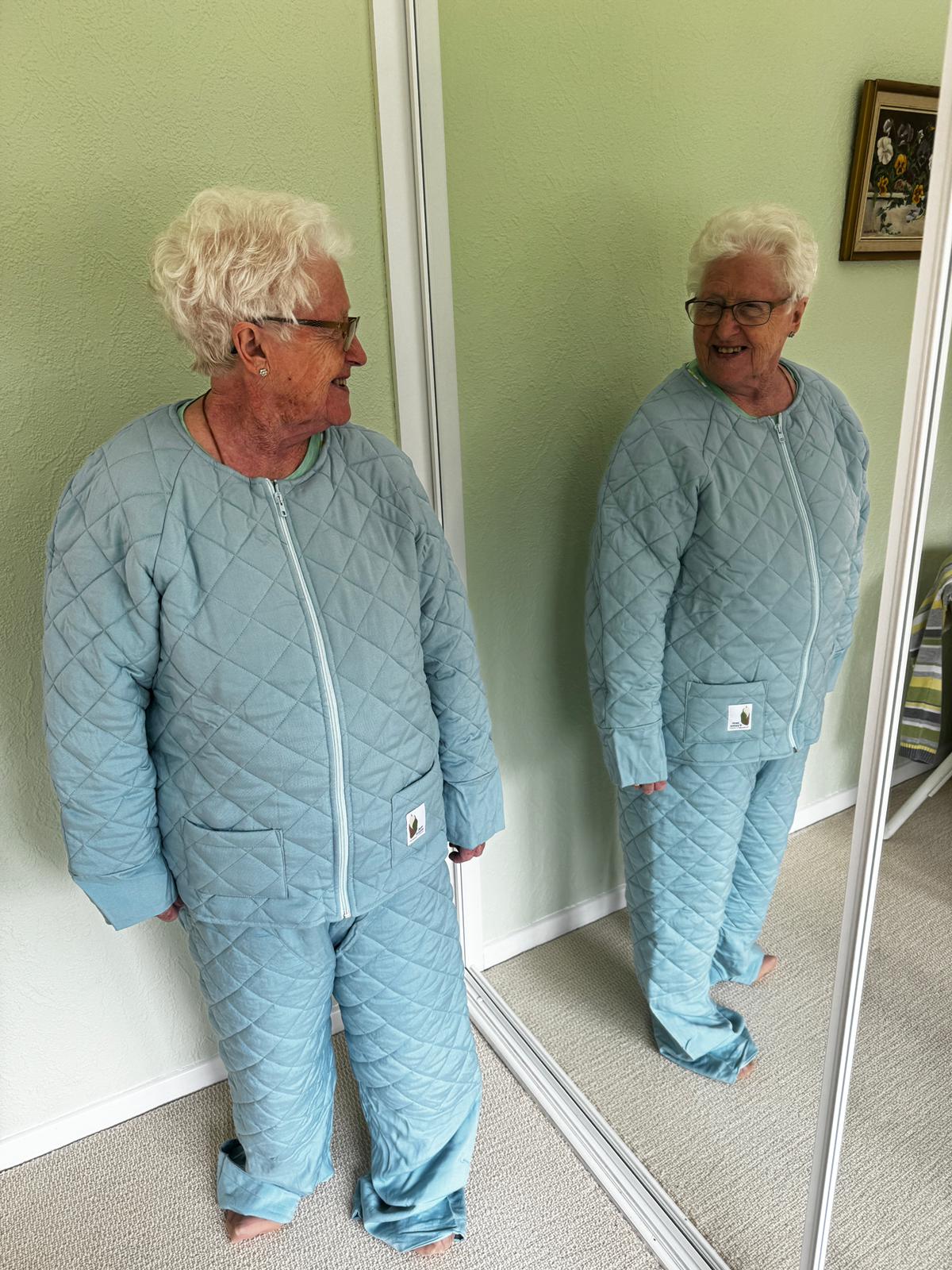 Woman looking in full length mirror wearing JemPJams Comfort Pyjama Bottoms and Comfort Pyjama Top
